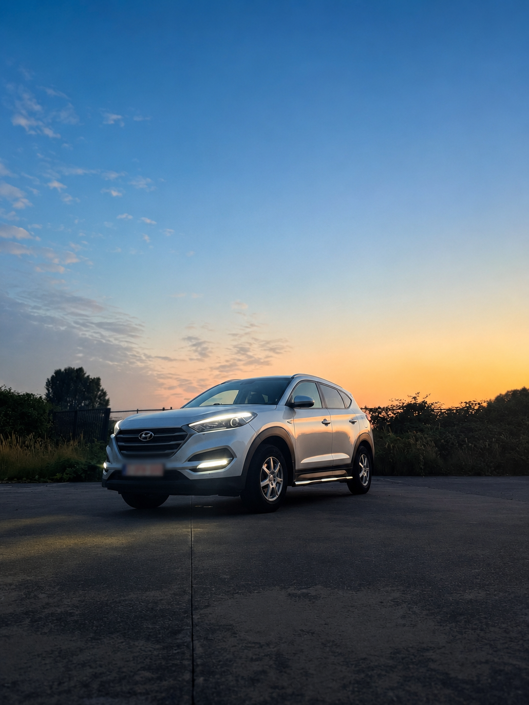 Hyundai Tucson private chauffeur SUV at sunset