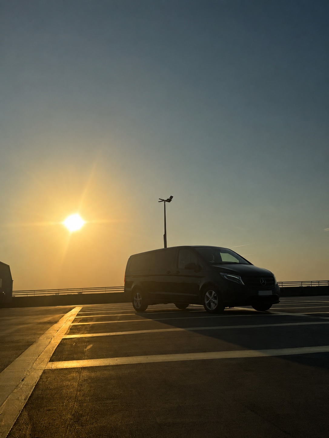 Luxury Mercedes chauffeur vehicle at sunset